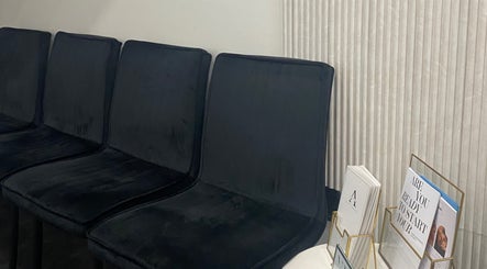 Comfortable black chairs in the waiting area at Atelier Hair & Beauty Studio in Bolton, England, GB.