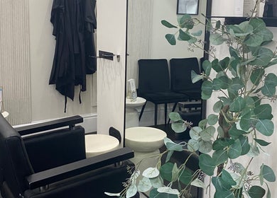Modern salon interior at Atelier Hair & Beauty Studio, Bolton, England, GB, featuring sleek chairs and elegant decor.