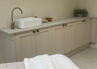 Stylish wash area at Atelier Hair & Beauty Studio, Bolton, England, GB features modern sink and gold faucet.