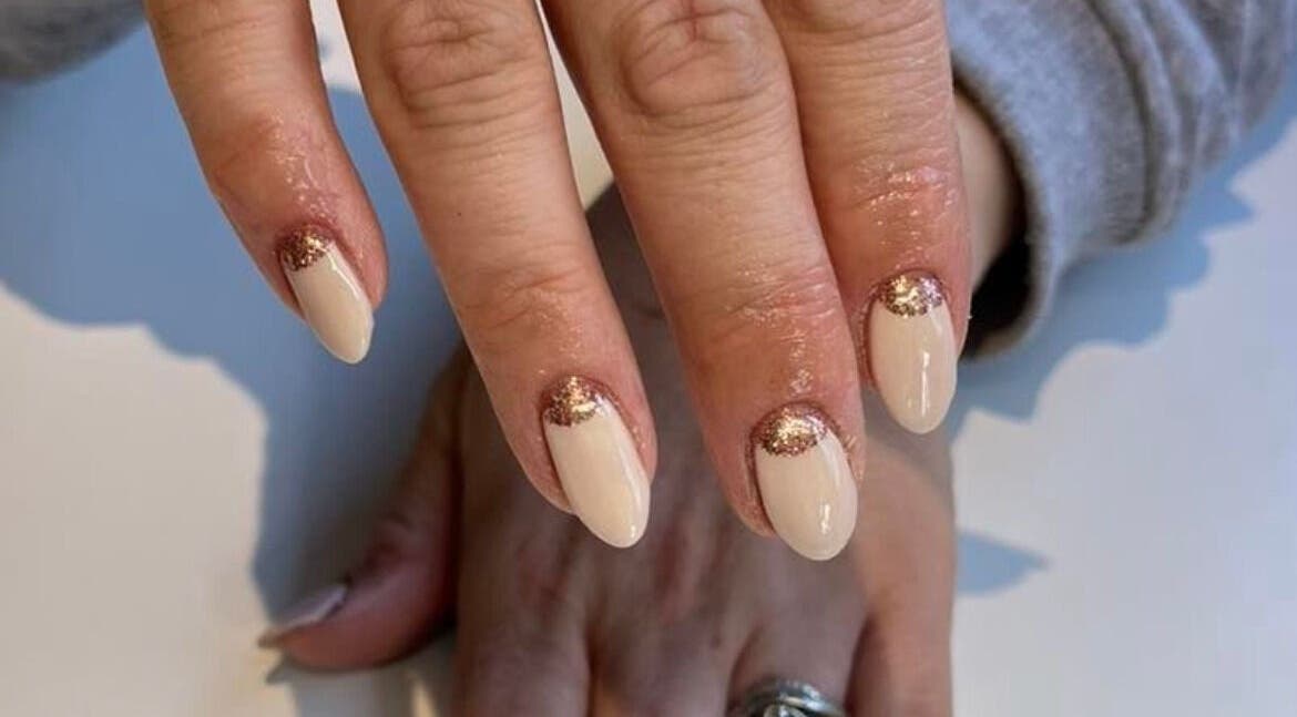 Stylish nude nails with glitter at Peak Perfection, Braintree, England, GB.