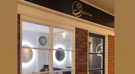 S Beauty Bar exterior with glowing mirrors in Northampton, England, GB.