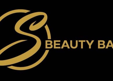 Logo of S Beauty Bar in Northampton, England, GB with gold lettering on black.
