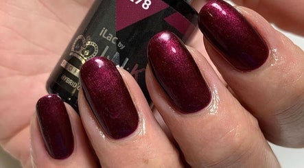 Elegant crimson nail art at Bellissima Beauty, Hitchin, England, GB, featuring glossy polish finish.
