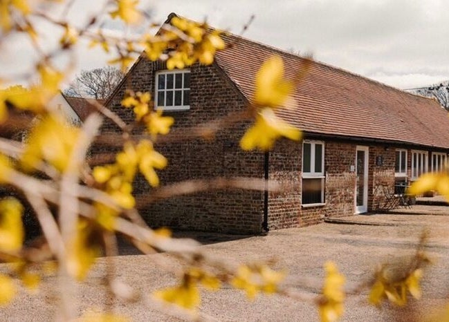 Reading Room Day Spa's rustic exterior with blooming flowers in Lewes, England, GB.