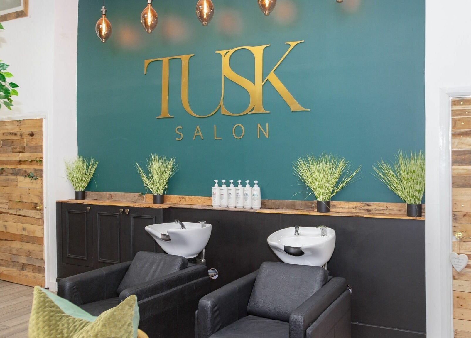 Stylish wash stations at Tusk Salon, Moreton, England, GB, with chic decor and modern design.