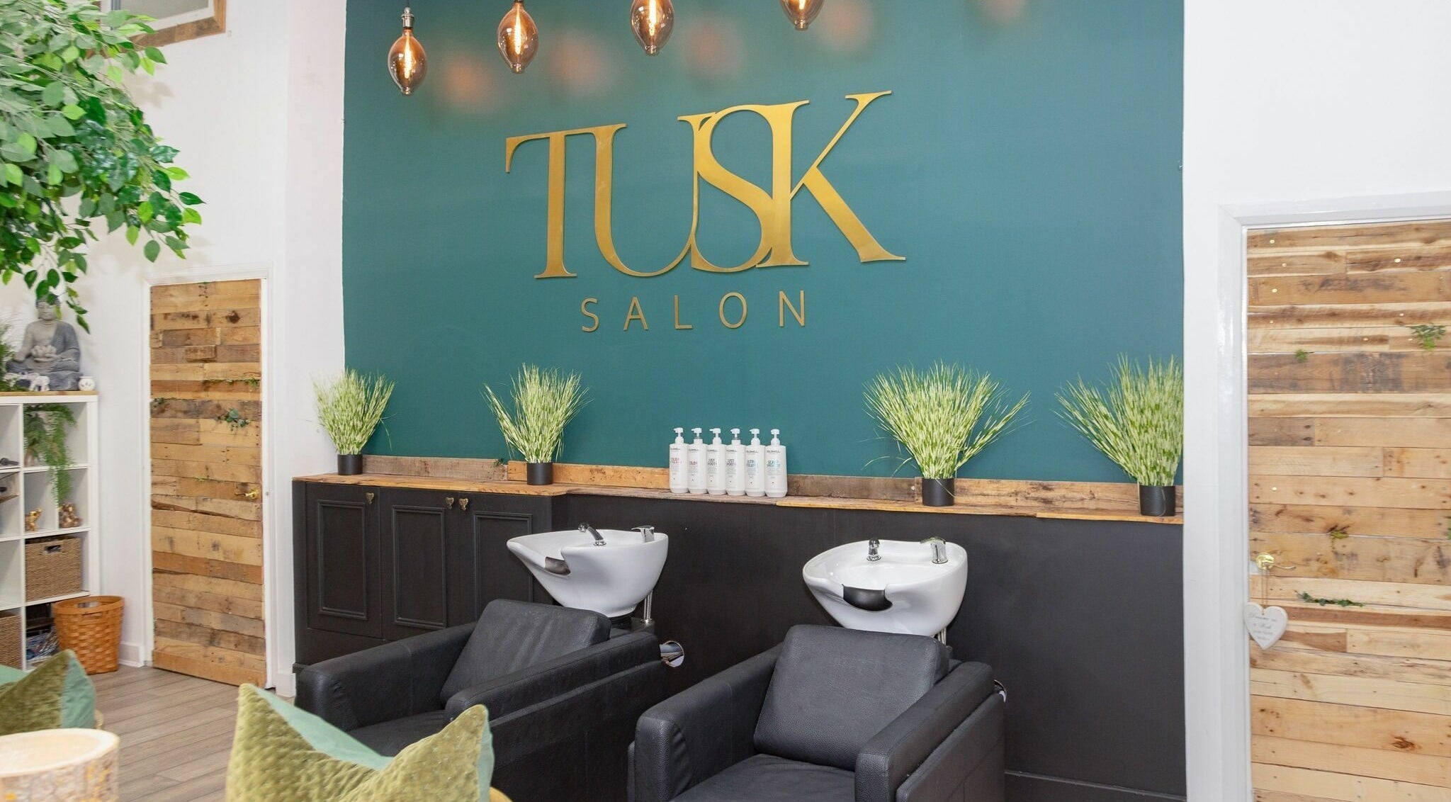 Stylish wash stations at Tusk Salon, Moreton, England, GB, with chic decor and modern design.