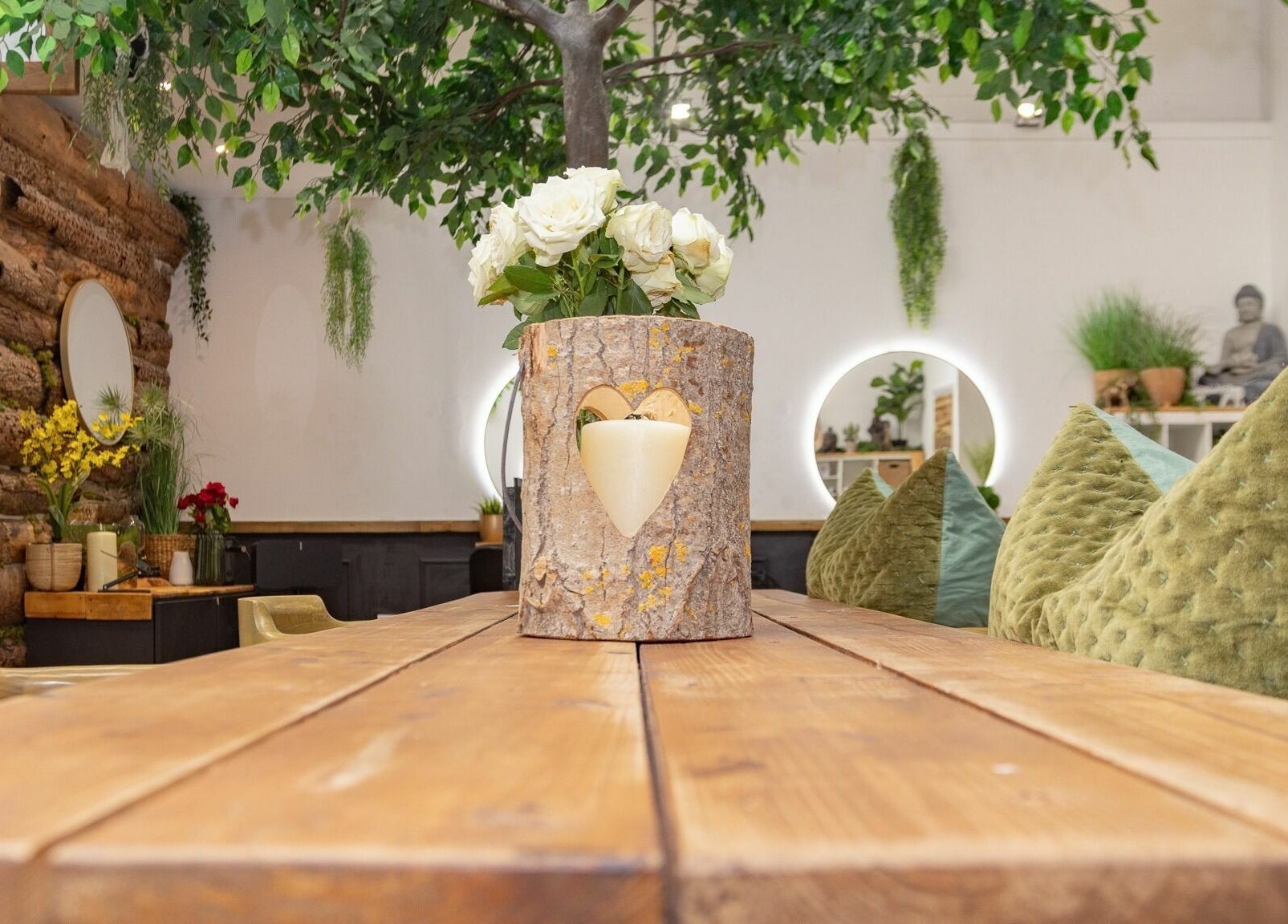 Tusk Salon in Moreton, England, GB, showcasing a rustic table with a tree decor and cozy ambiance.
