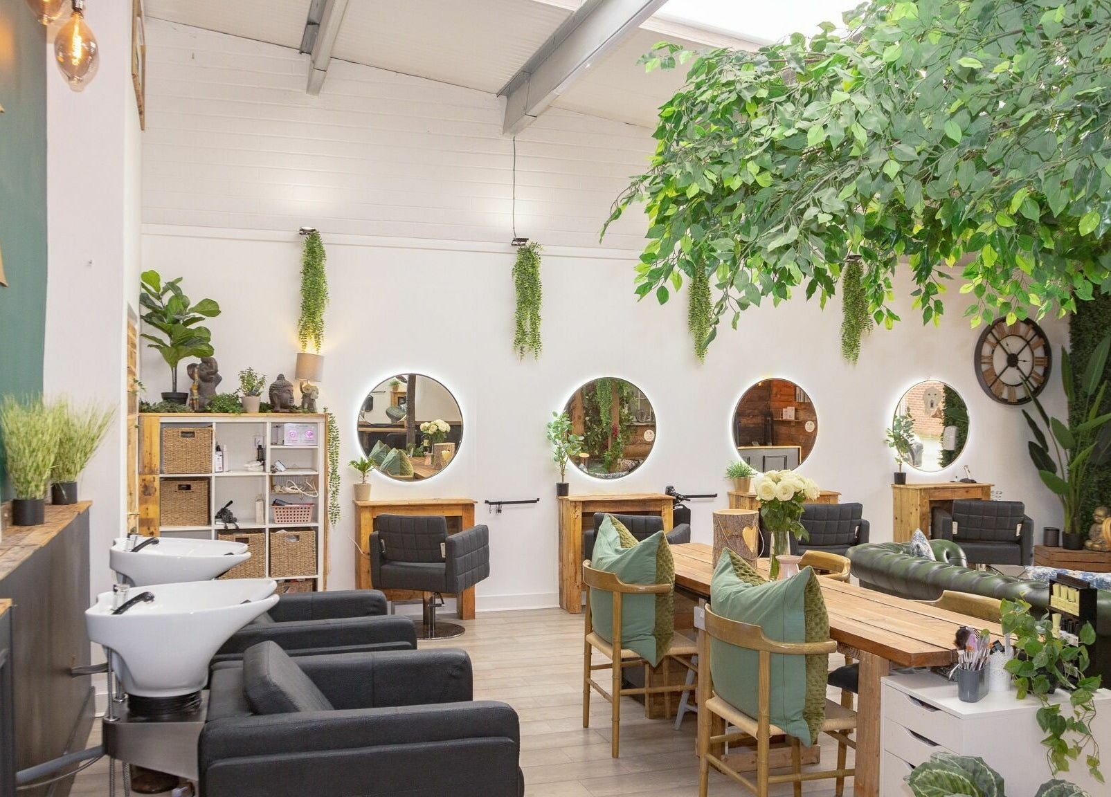 Bright, inviting interior of Tusk Salon, Moreton, England, GB, featuring greenery and modern decor.