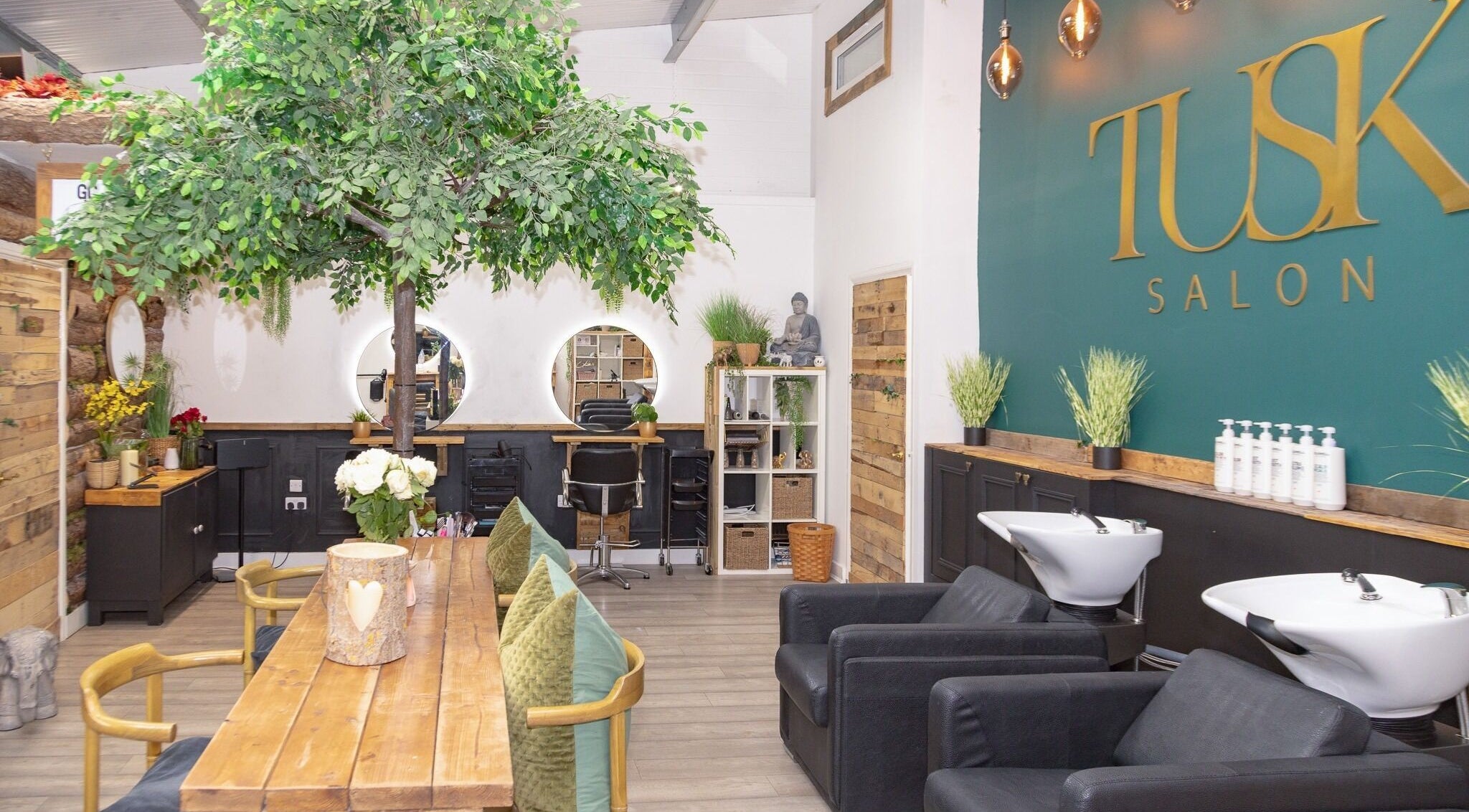 Interior of Tusk Salon in Moreton, England, GB featuring lush decor and modern styling stations.