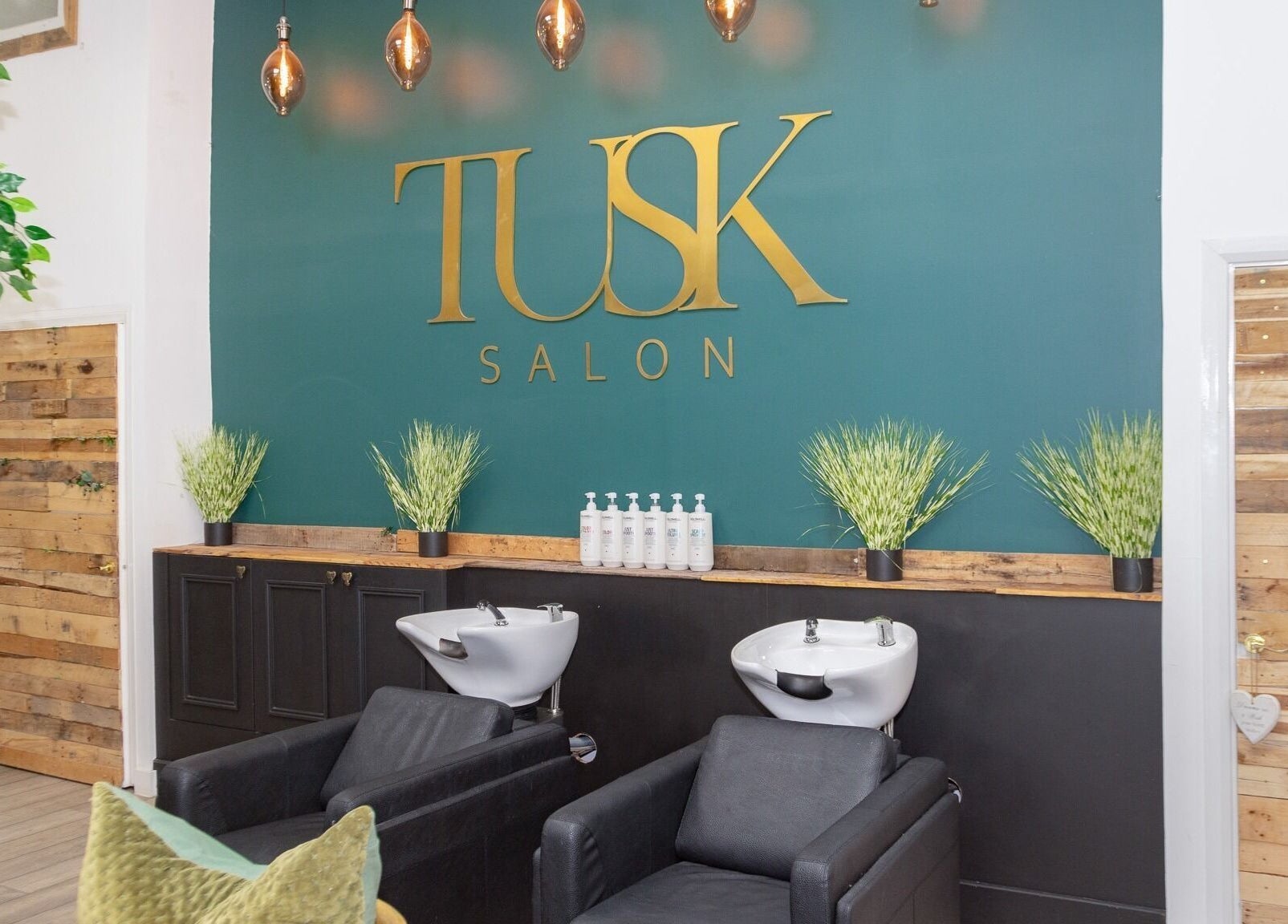 Elegant wash stations at Tusk Salon, Moreton, England, GB, featuring stylish decor and modern design.