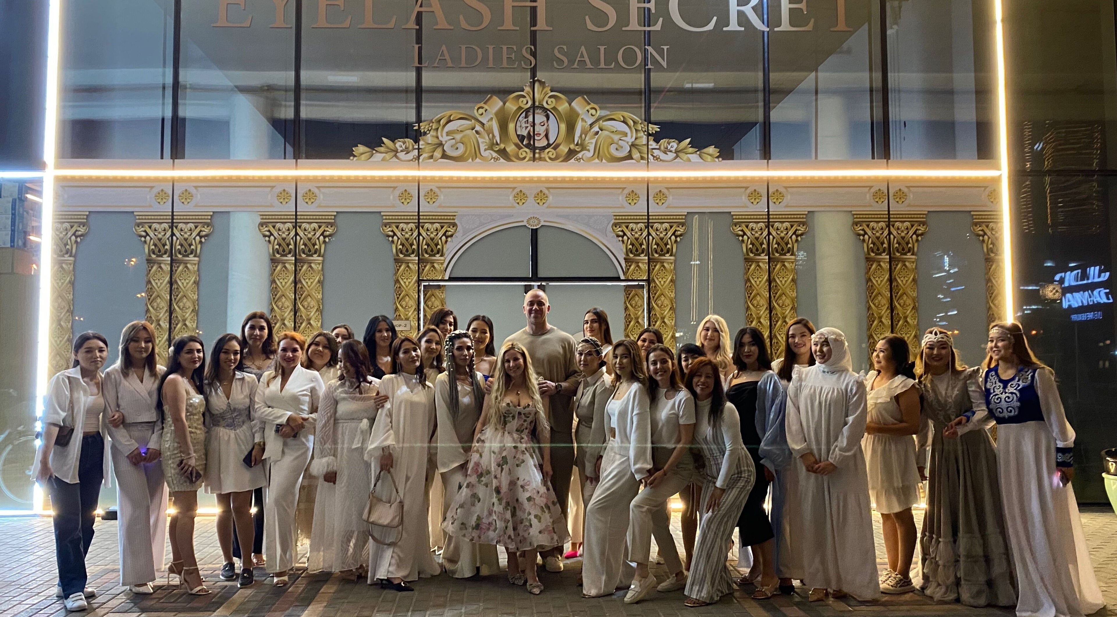 Group photo outside Eyelash Secret Ladies Salon Damac Voleo in Dubai, AE, showcasing happy clients and staff.