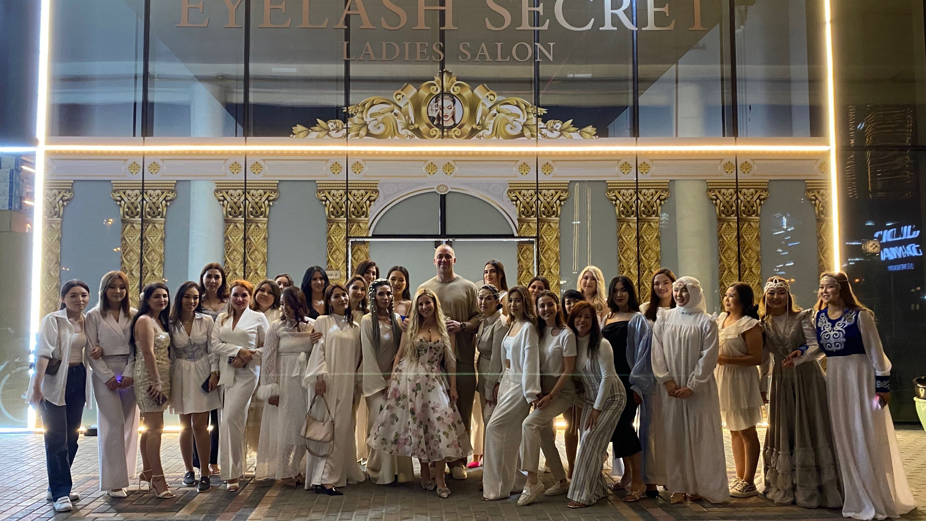 Group photo outside Eyelash Secret Ladies Salon Damac Voleo in Dubai, AE, showcasing happy clients and staff.