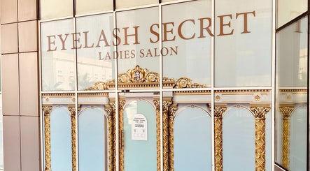 Entrance of Eyelash Secret Ladies Salon Damac Voleo in Dubai, AE, showcasing ornate gold design and signage.