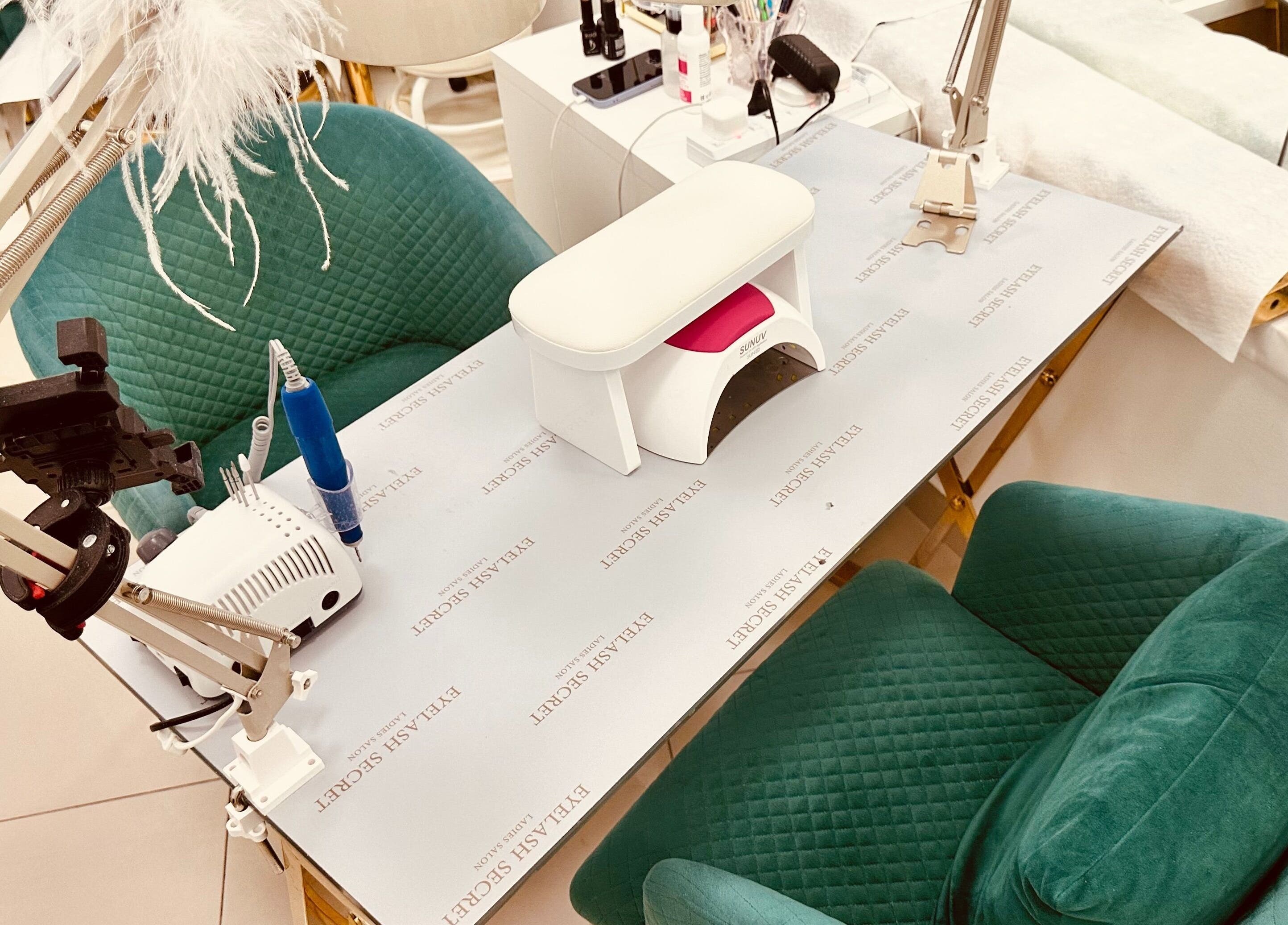 Modern nail station at Eyelash Secret Ladies Salon Damac Voleo, Dubai, AE showcasing luxury green seating.