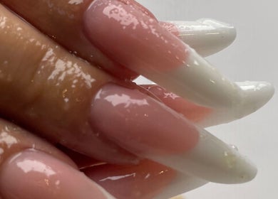 Elegant nail art at Eyelash Secret Ladies Salon Iris Bay, Dubai, Dubai, AE, showcasing glossy pink and white designs.