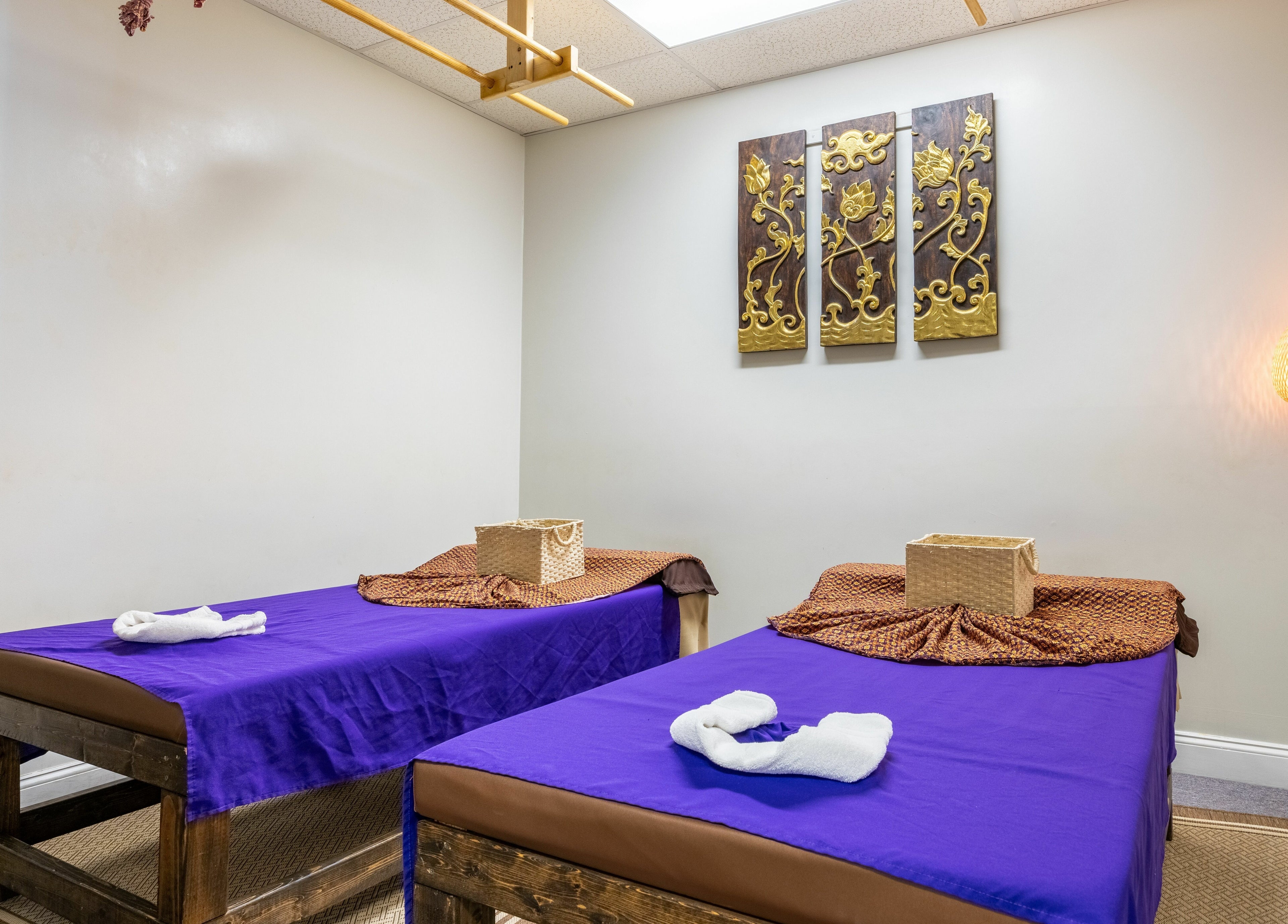 Tranquil massage room at La Moon Thai Spa Wilmington, Massachusetts with twin beds and calming decor.