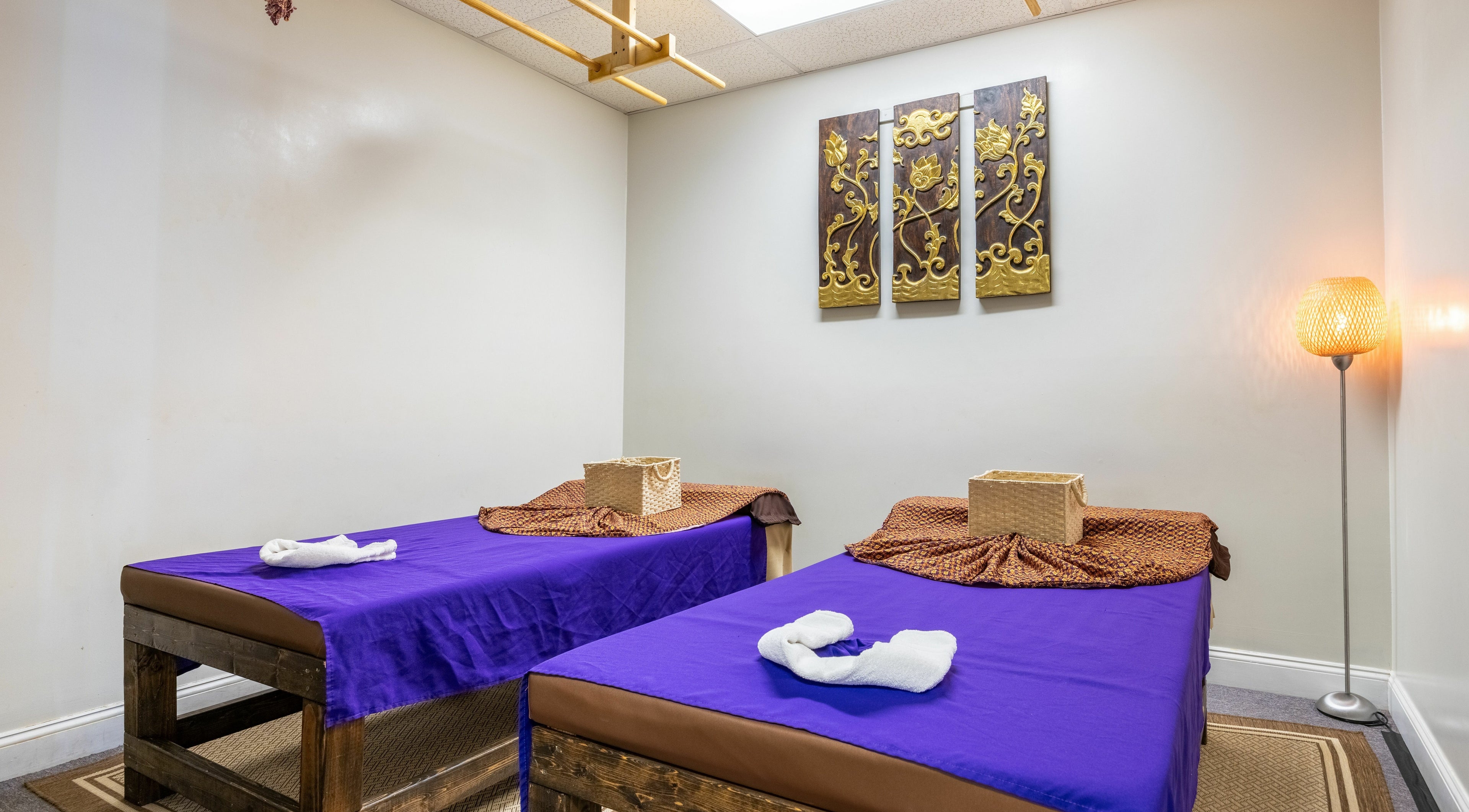 Tranquil massage room at La Moon Thai Spa Wilmington, Massachusetts with twin beds and calming decor.