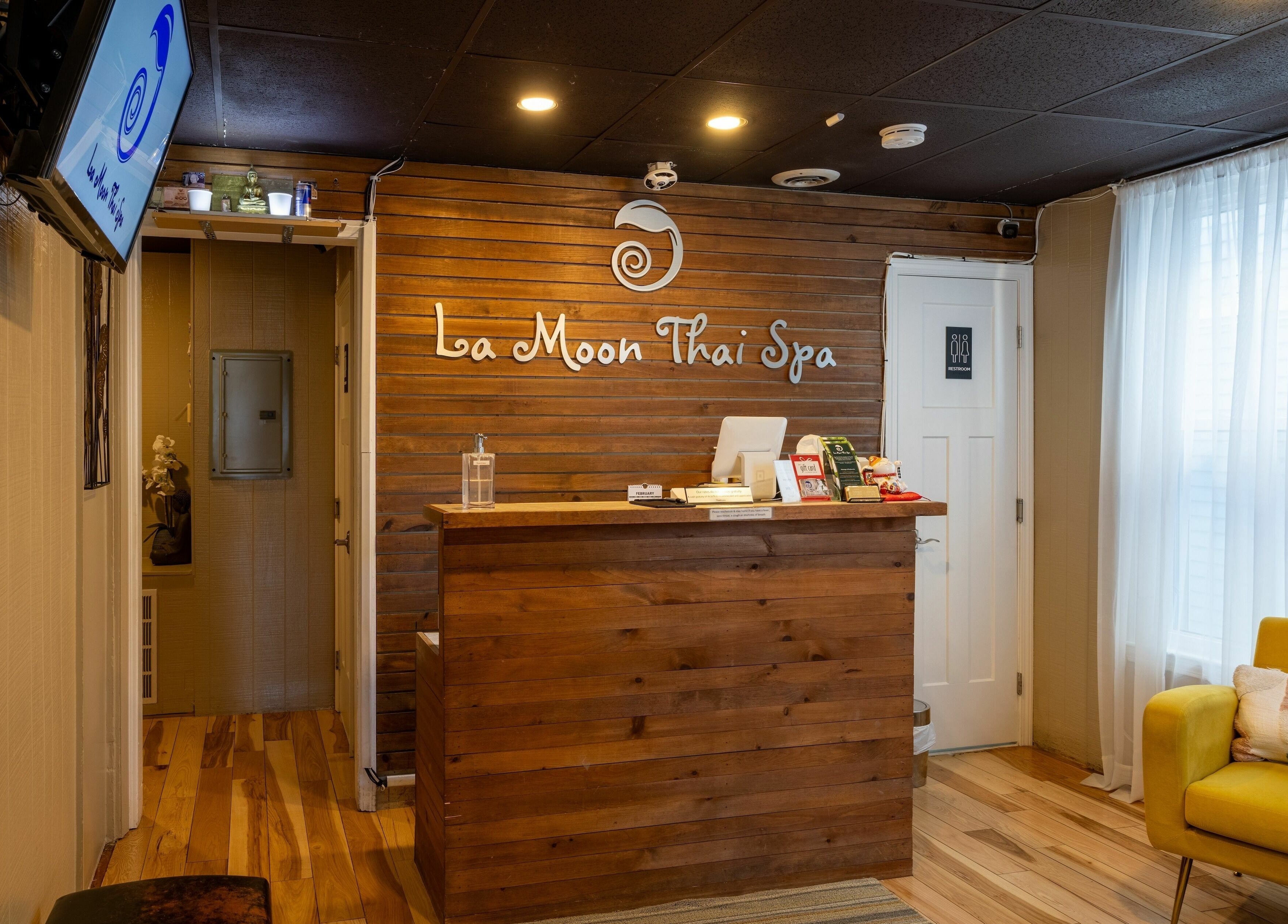 Reception area of La Moon Thai Spa Cambridge, elegant wooden decor, Cambridge, Massachusetts, US.