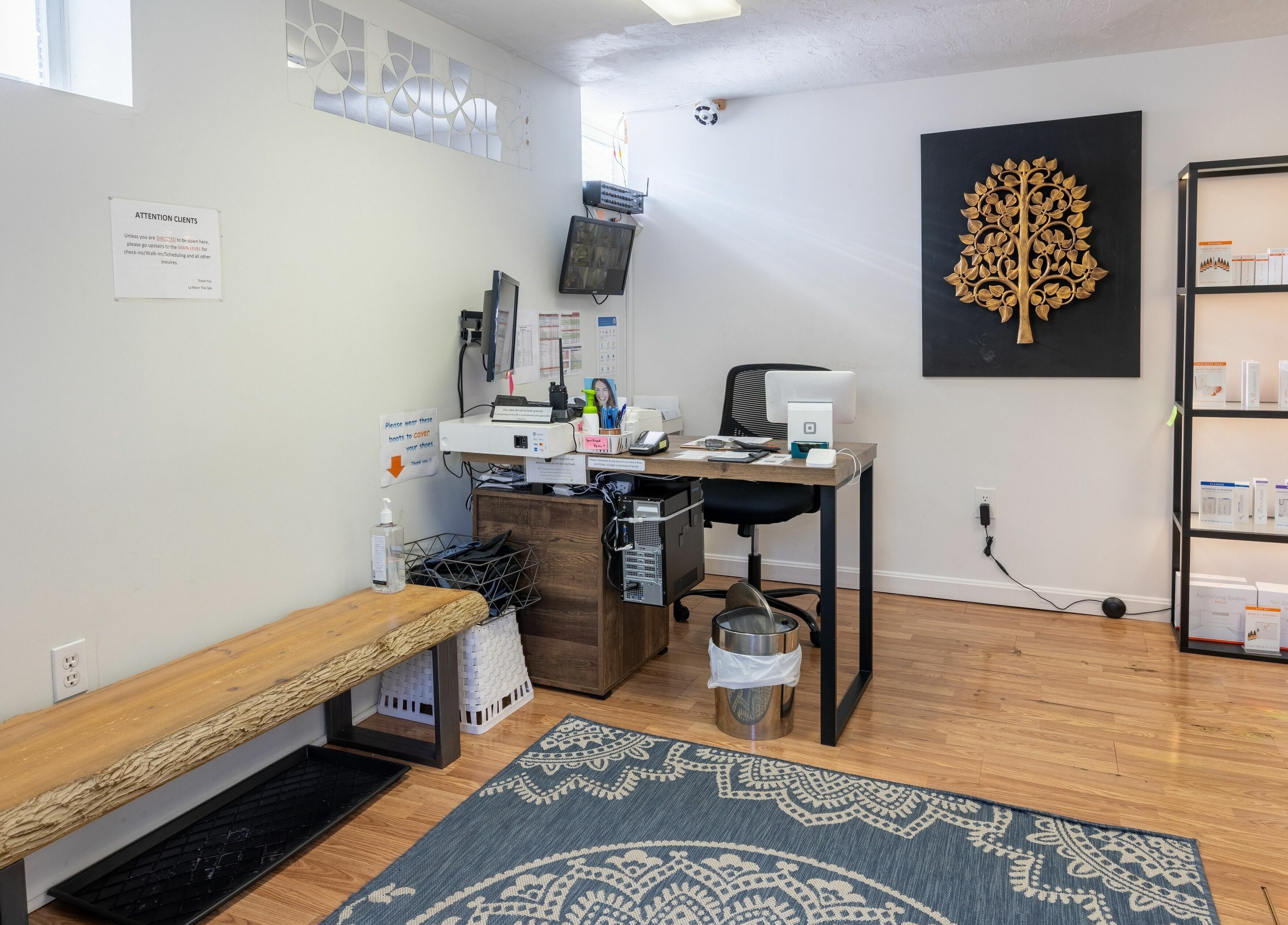 Reception area at La Moon Thai Spa Cambridge with a decorative wall art in Cambridge, Massachusetts, US.