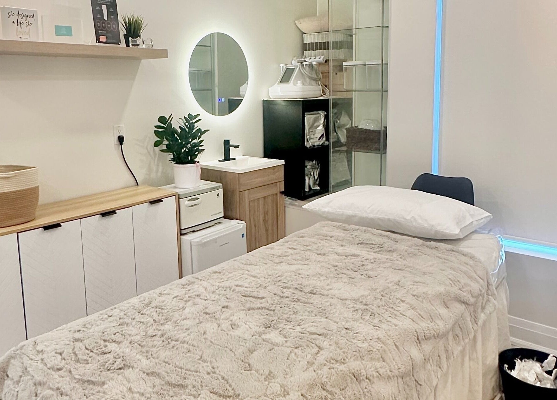 Relaxing spa room at SPAMUZE in Toronto, Ontario, CA with luxury linens and modern decor.