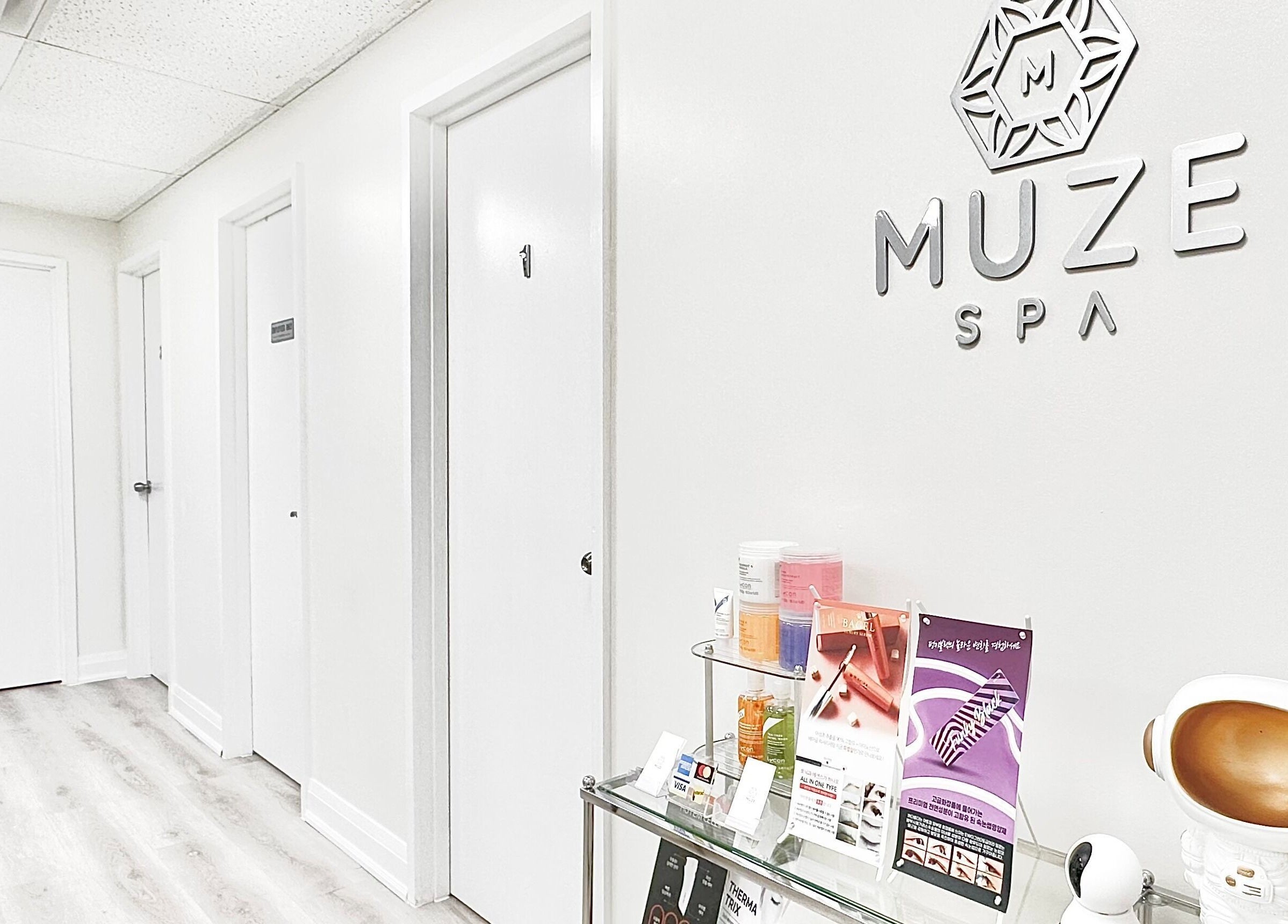 Bright hallway in SPAMUZE, Toronto, Ontario, CA, showcasing spa entrance with products displayed.