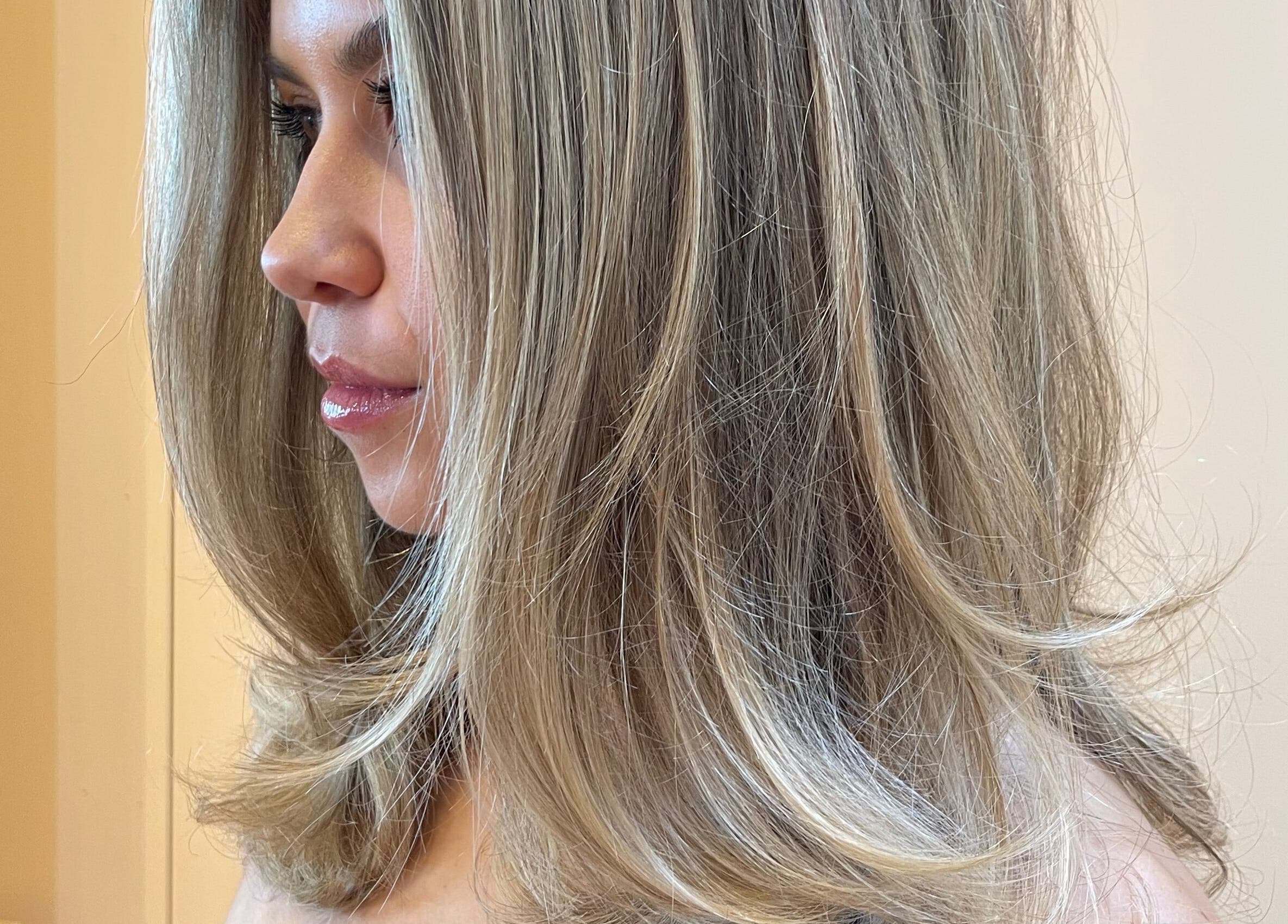 A woman with styled, blonde hair at Imogen Coates, London, England, GB, showcasing a sleek and modern hairstyle.