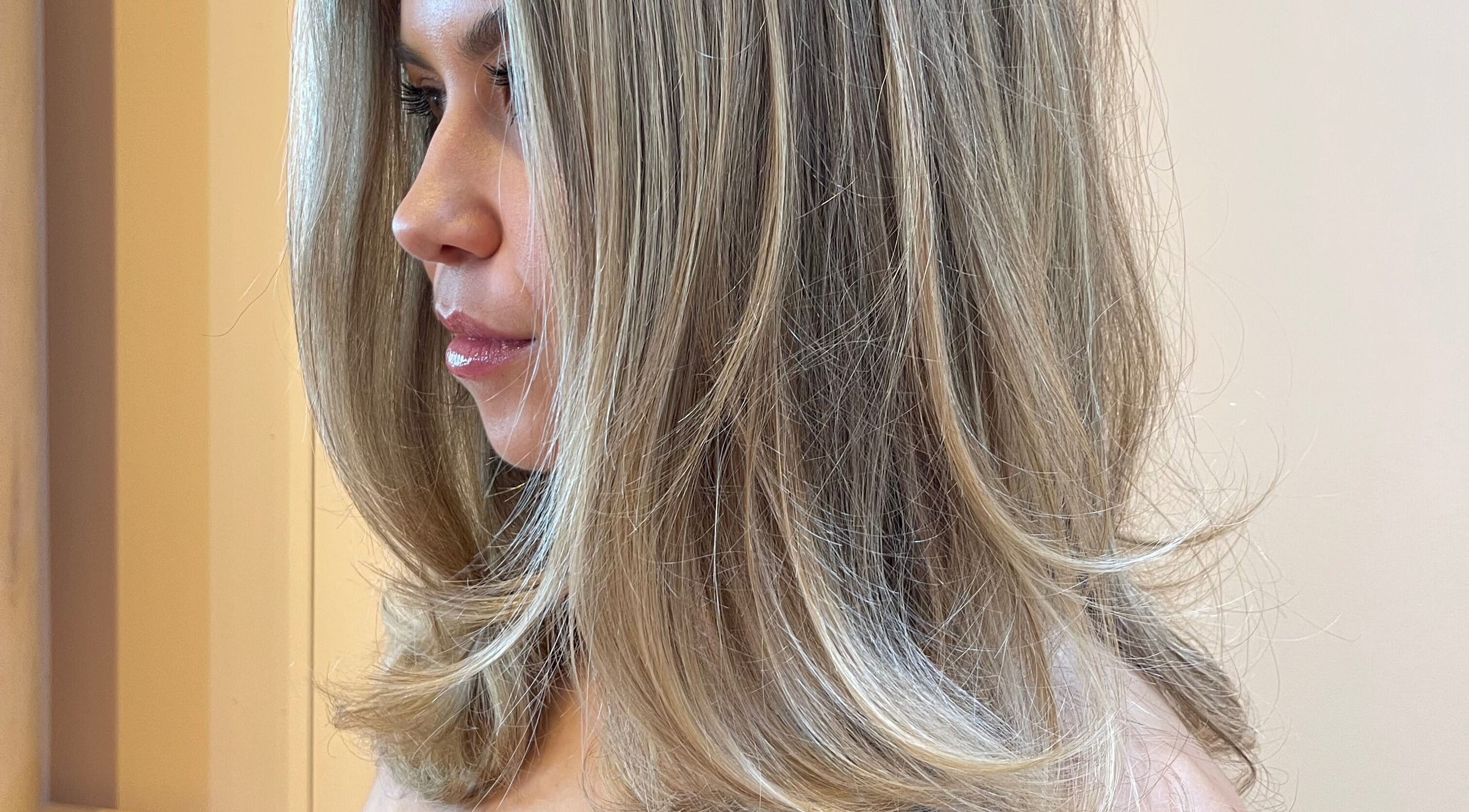A woman with styled, blonde hair at Imogen Coates, London, England, GB, showcasing a sleek and modern hairstyle.