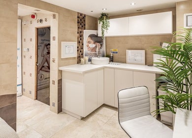 Elegant treatment room at Anir Anun Clinic, London, England, GB, featuring modern decor and plush seating.