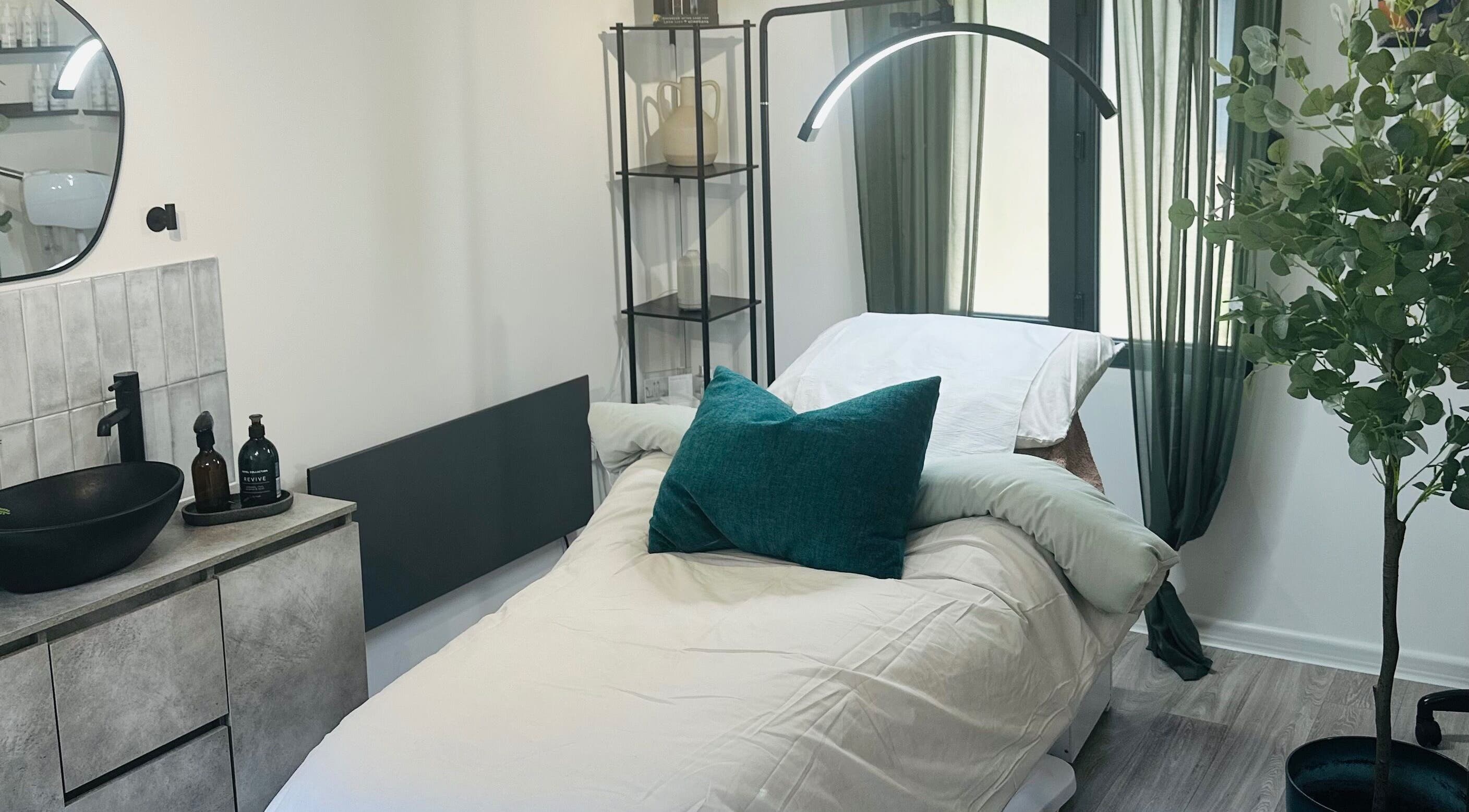 Tranquil treatment room at Bare, Southampton, England, GB, featuring a cushioned bed and stylish decor.