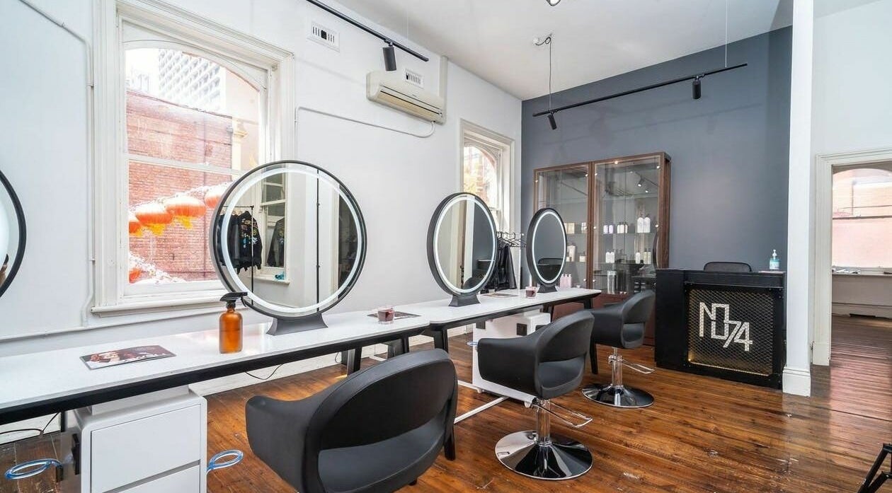 Modern interior of No.74 Hair Salon in Melbourne, Victoria, AU with stylish chairs and mirrors.