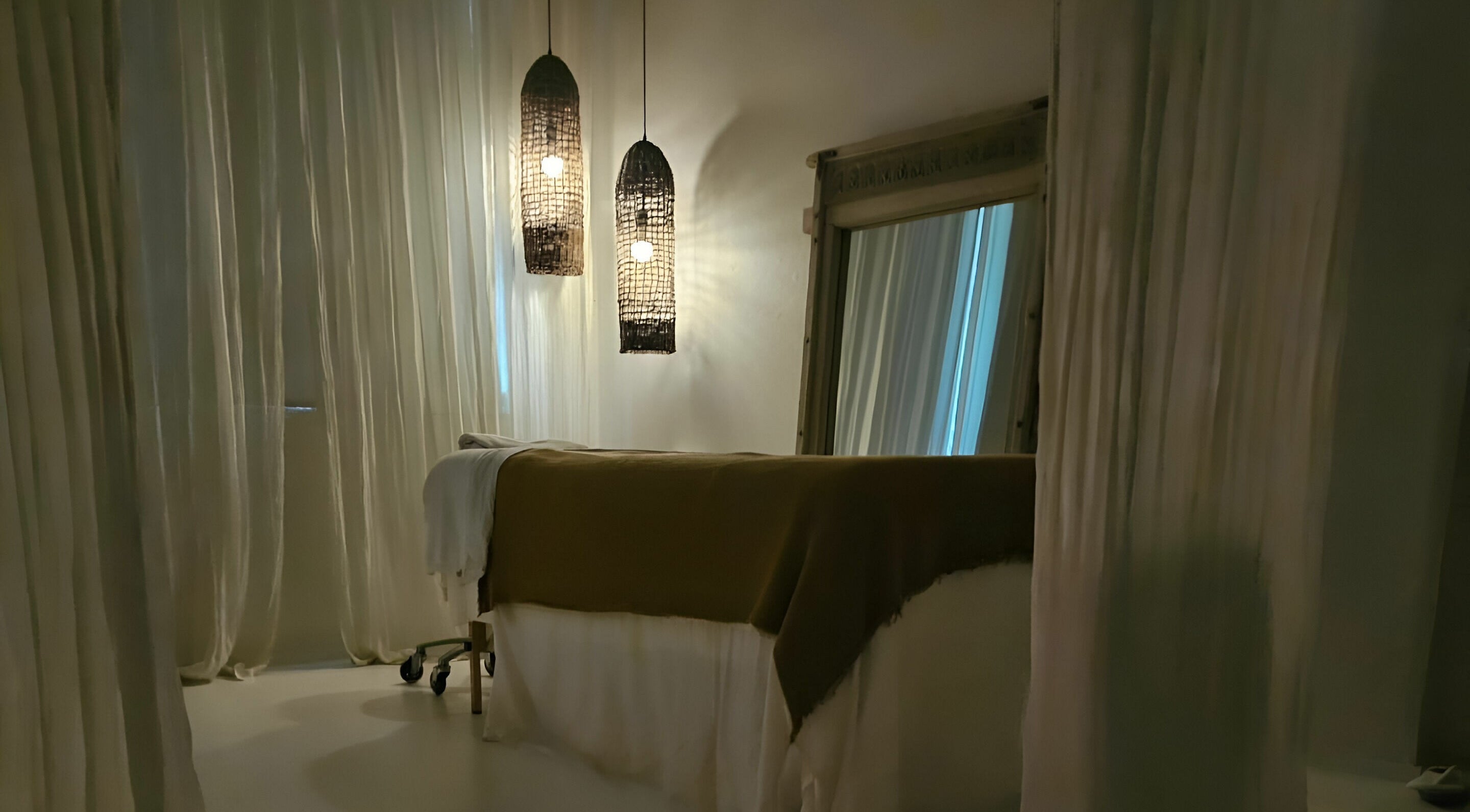 Relaxing treatment room at Chakana Day Spa + Wellbeing, Avalon Beach, New South Wales, AU with calming lighting.