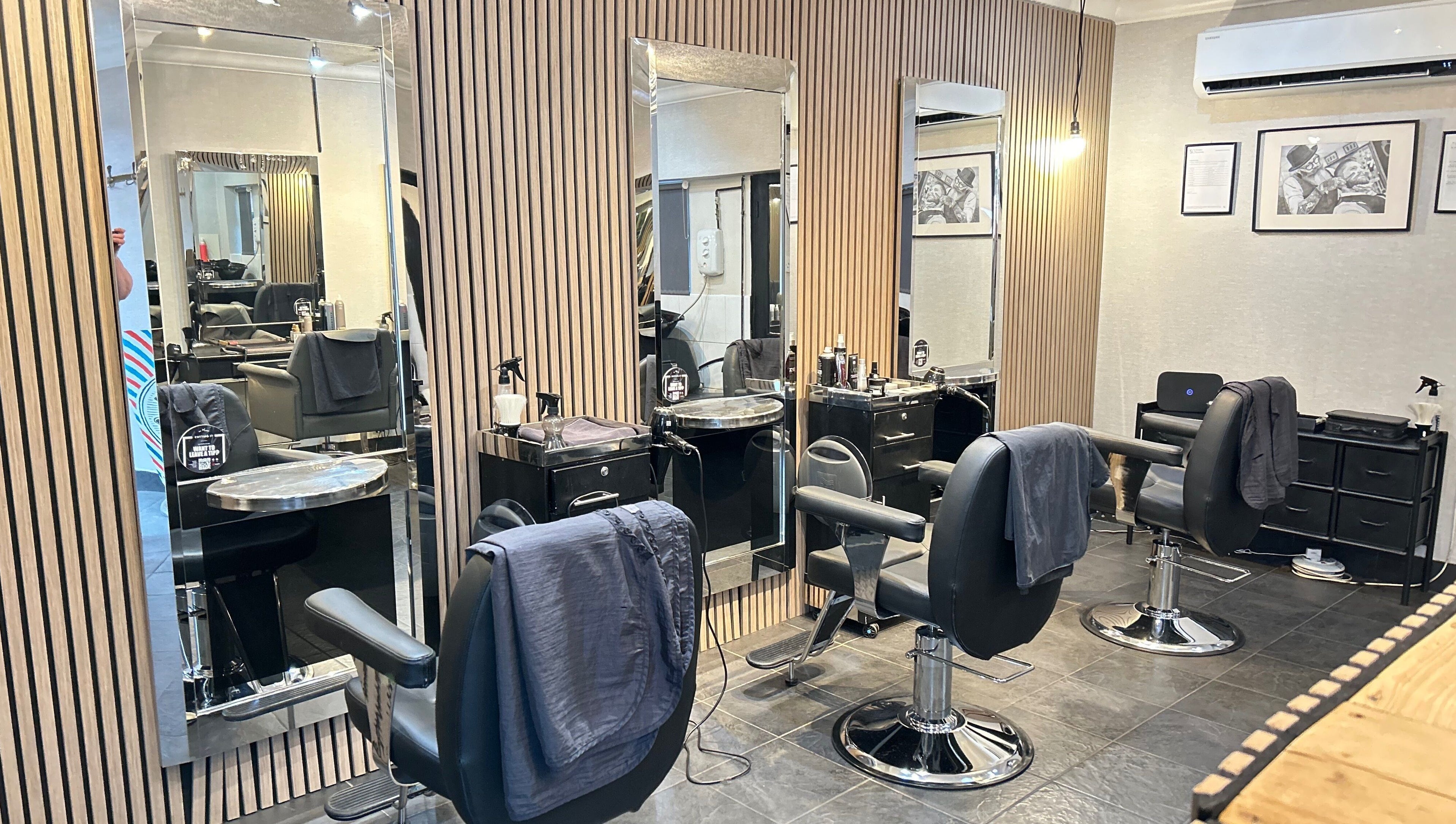 Modern salon interior at Cutting It, Bracebridge Heath, England, GB, featuring sleek styling stations.