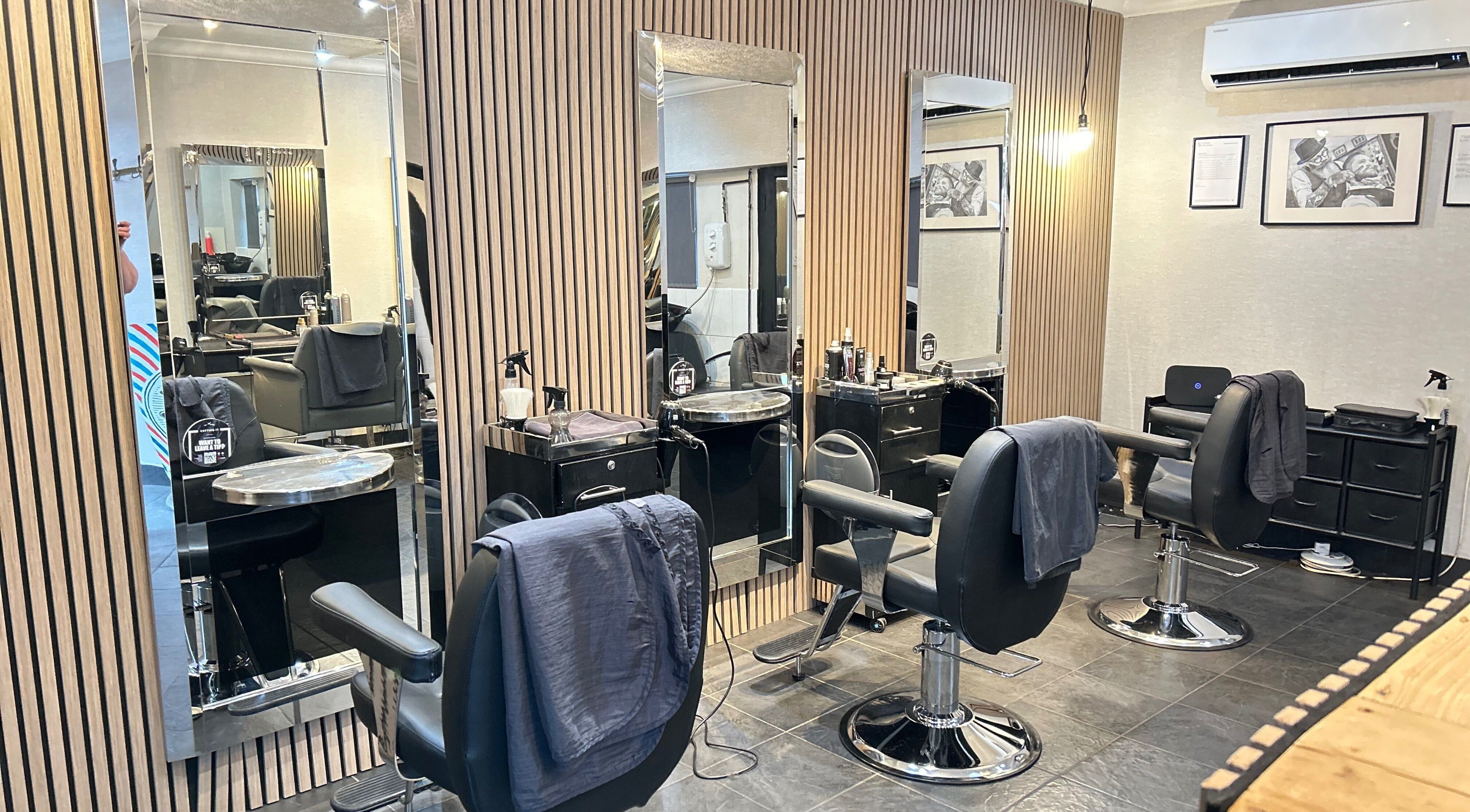 Modern salon interior at Cutting It, Bracebridge Heath, England, GB, featuring sleek styling stations.