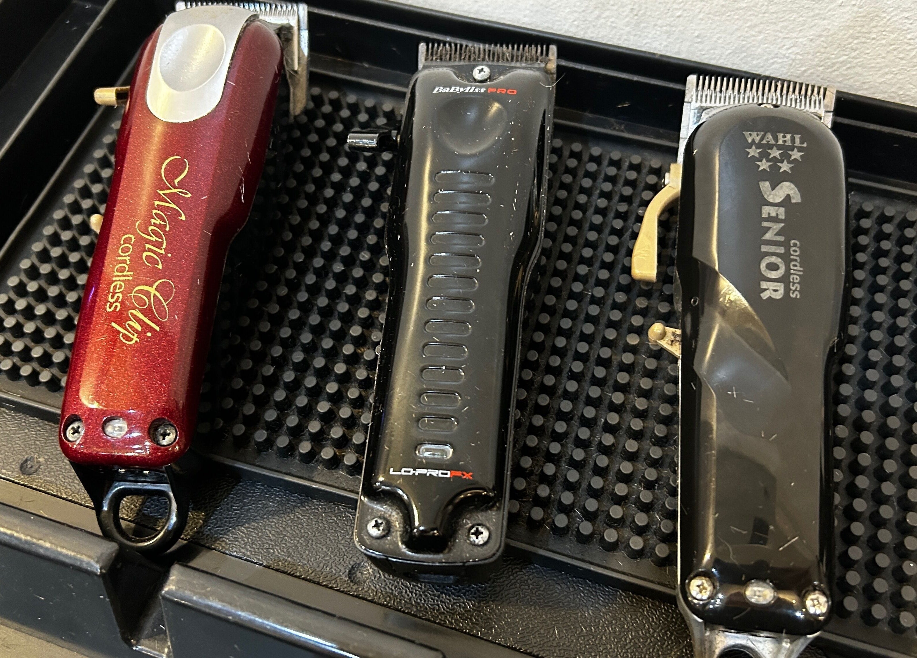 Professional hair clippers at Cutting It in Bracebridge Heath, England, GB on a black tray.