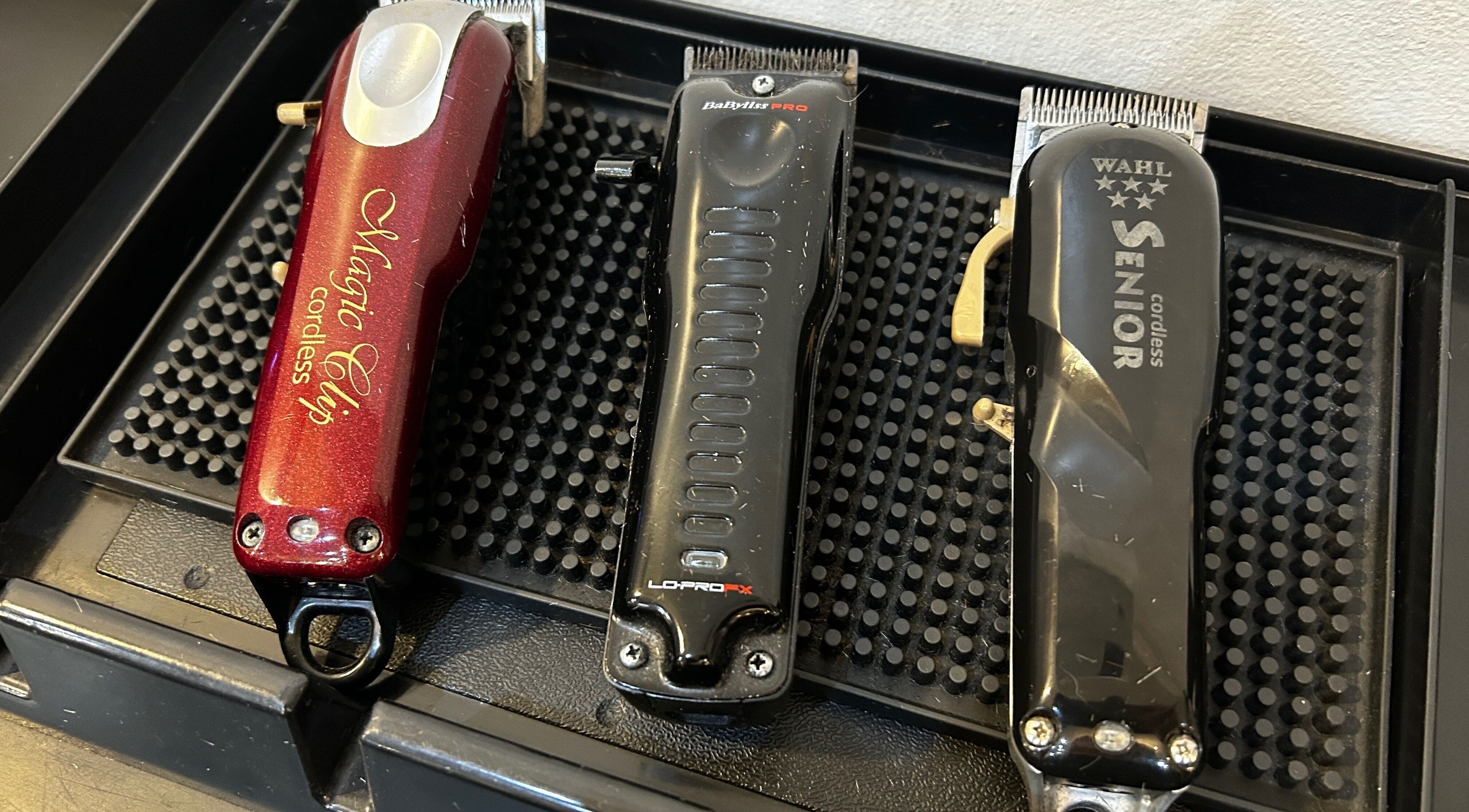Professional hair clippers at Cutting It in Bracebridge Heath, England, GB on a black tray.
