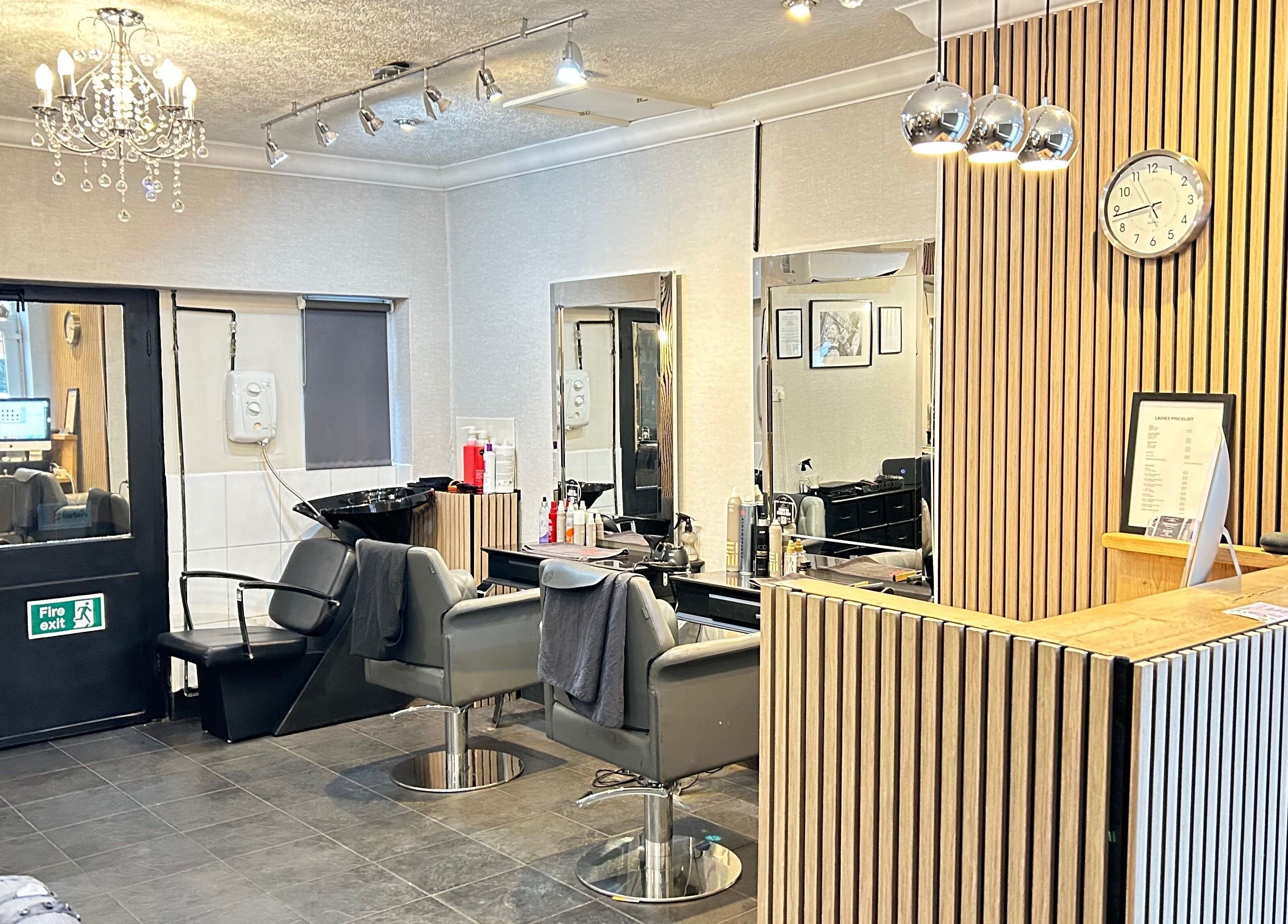 Modern salon interior at Cutting It, Bracebridge Heath, England, GB showcasing styling chairs and welcoming decor.