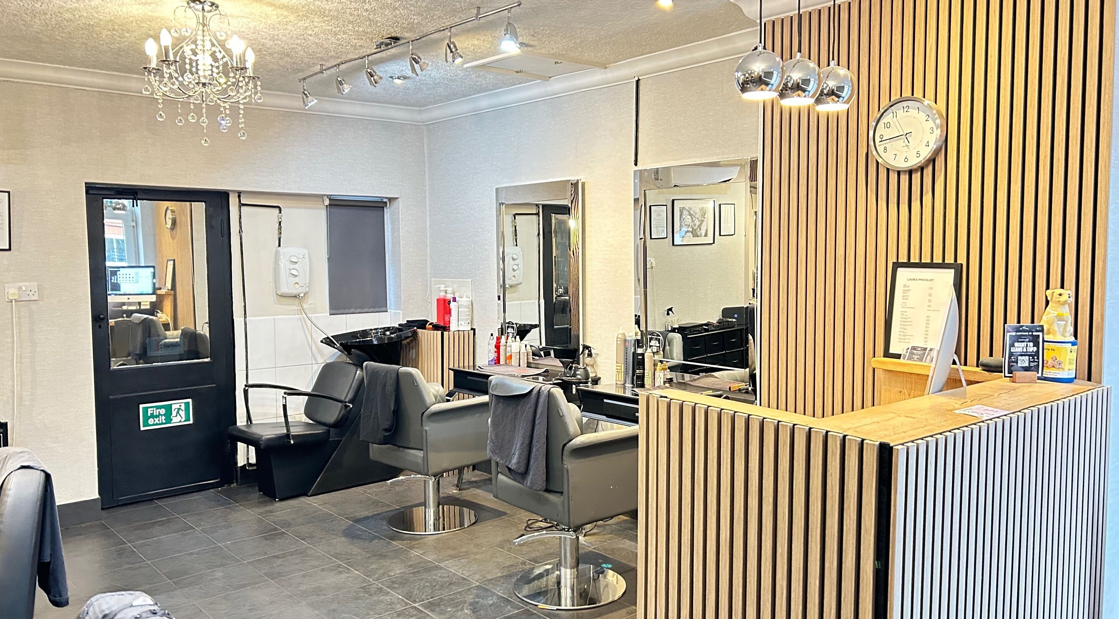 Modern salon interior at Cutting It, Bracebridge Heath, England, GB showcasing styling chairs and welcoming decor.
