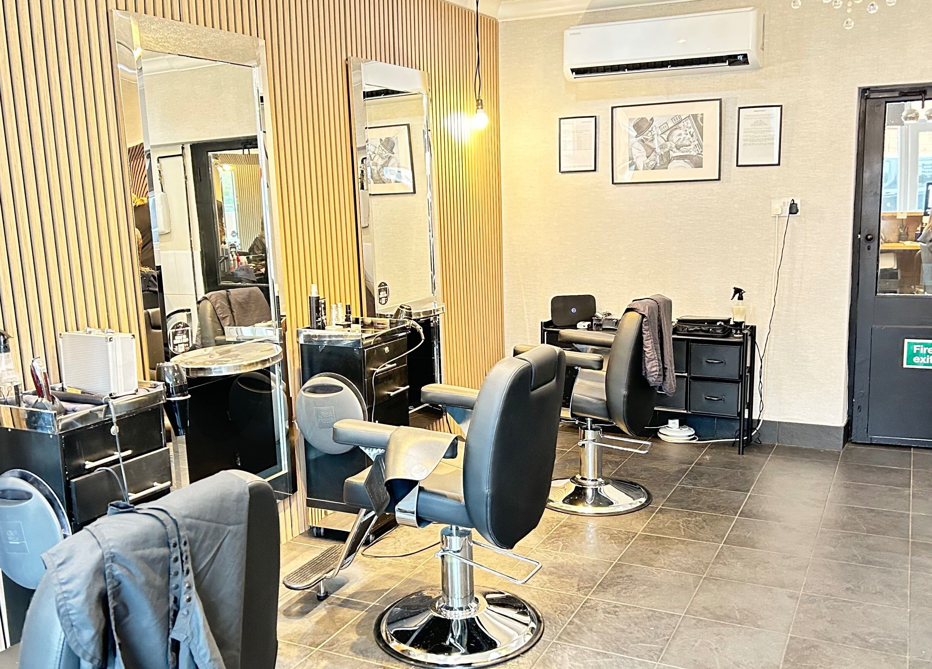 Modern salon interior at Cutting It, Bracebridge Heath, England, GB with stylish chairs and large mirrors.