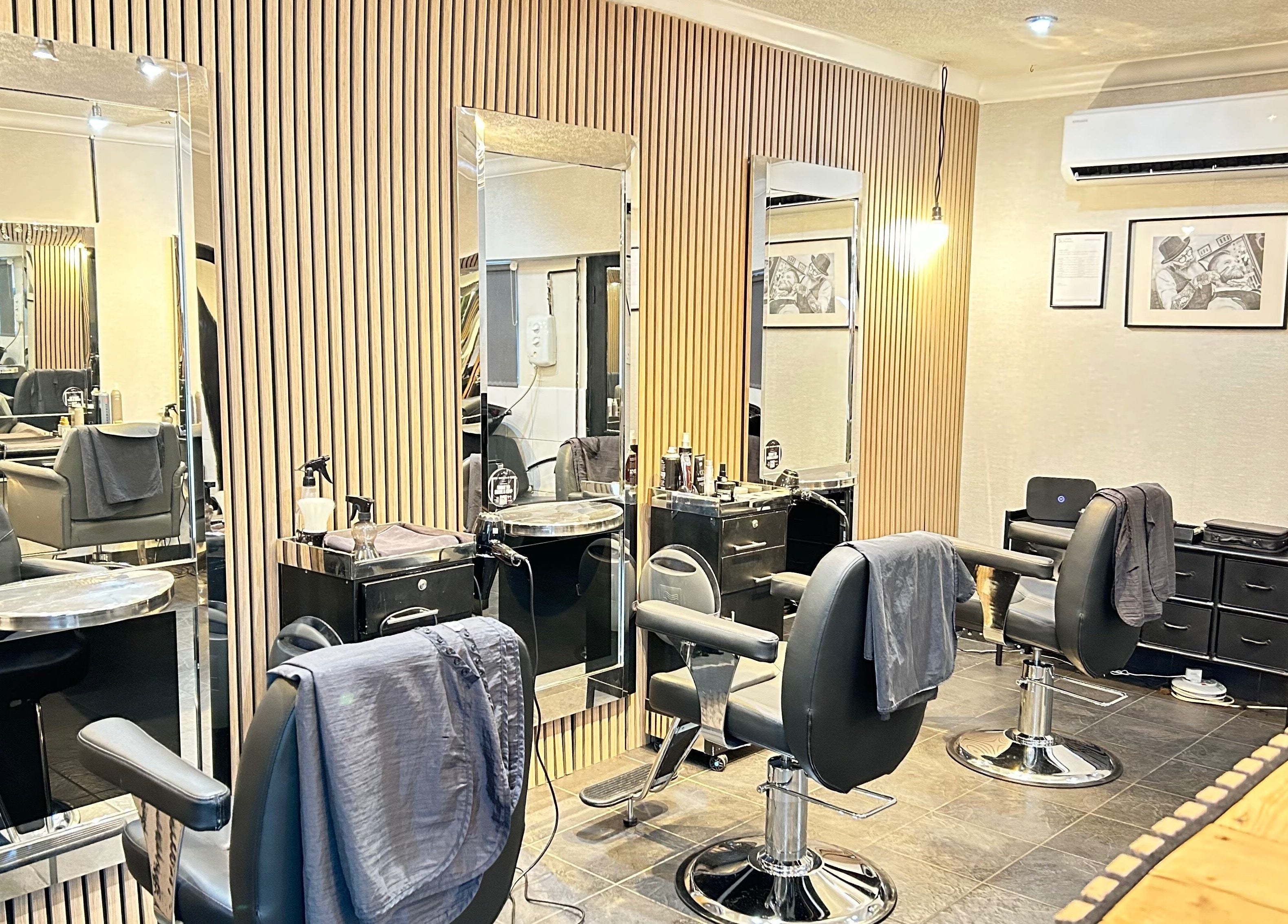 Modern salon interior at Cutting It, Bracebridge Heath, England, GB featuring stylish stations and seating.