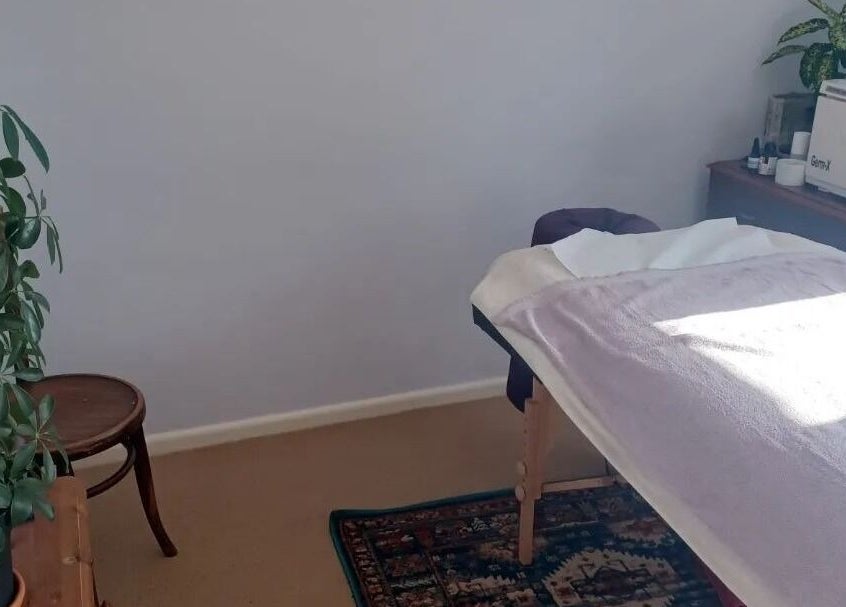 Serene treatment room at Caring For You Treatments in Salwayash, England, GB with a massage table and plants.