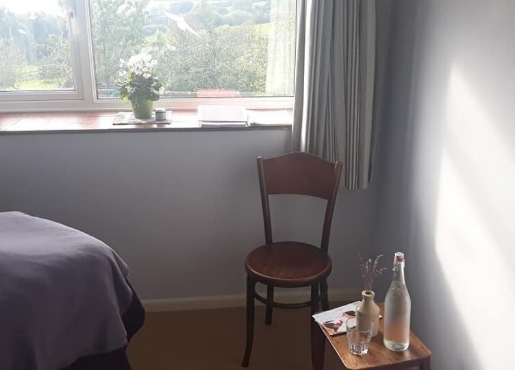 Serene treatment room at Caring For You Treatments, Salwayash, England, GB, with scenic outdoor view.