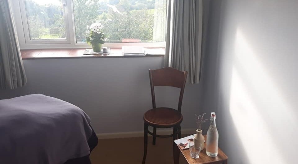 Serene treatment room at Caring For You Treatments, Salwayash, England, GB, with scenic outdoor view.