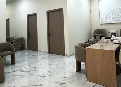 Elegant, modern interior of Skin Harmony Beauty Salon, Dubai, Dubai, AE with plush seating and marble floors.