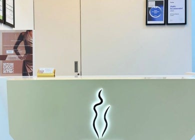 Reception desk at Skin Harmony Beauty Salon, Dubai, Dubai, AE, with stylish decor and certificates displayed.