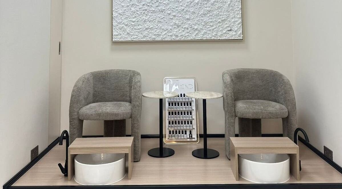 Elegant pedicure area at Skin Harmony Beauty Salon in Dubai, Dubai, AE showcasing modern seating and stylish decor.