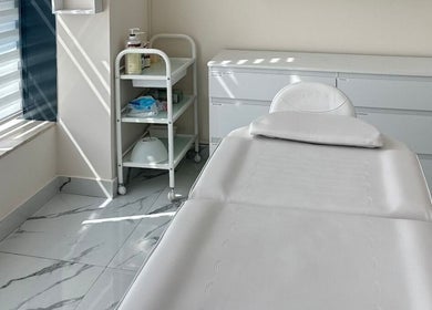 Serene treatment room at Skin Harmony Beauty Salon, Dubai, Dubai, AE with bed and skincare essentials.