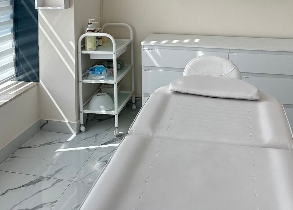 Serene treatment room at Skin Harmony Beauty Salon, Dubai, Dubai, AE with bed and skincare essentials.