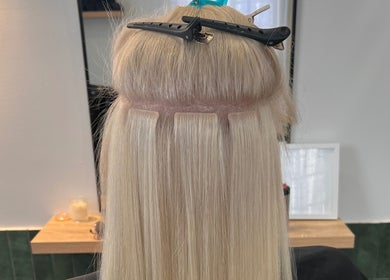 Hair extensions in progress at Hair by Denielle in Kedron, Queensland, AU. Creating stunning long, blonde hair.
