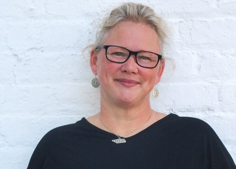 Smiling person at So Kno Bliss Salon, showcasing elegant style in Knoxville, Tennessee, US.