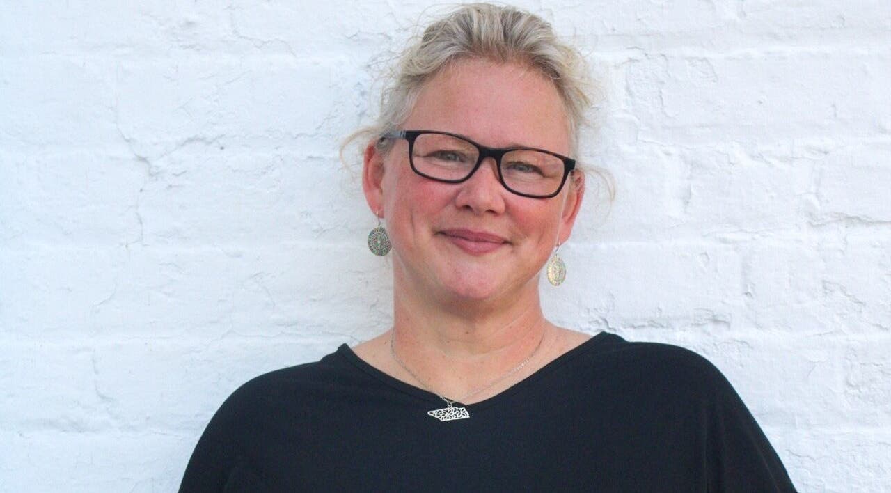 Smiling person at So Kno Bliss Salon, showcasing elegant style in Knoxville, Tennessee, US.